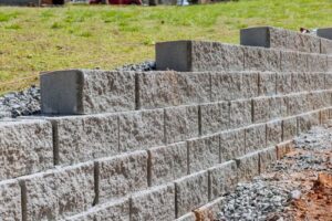 a retaining wall being assembled with advanced concrete forms